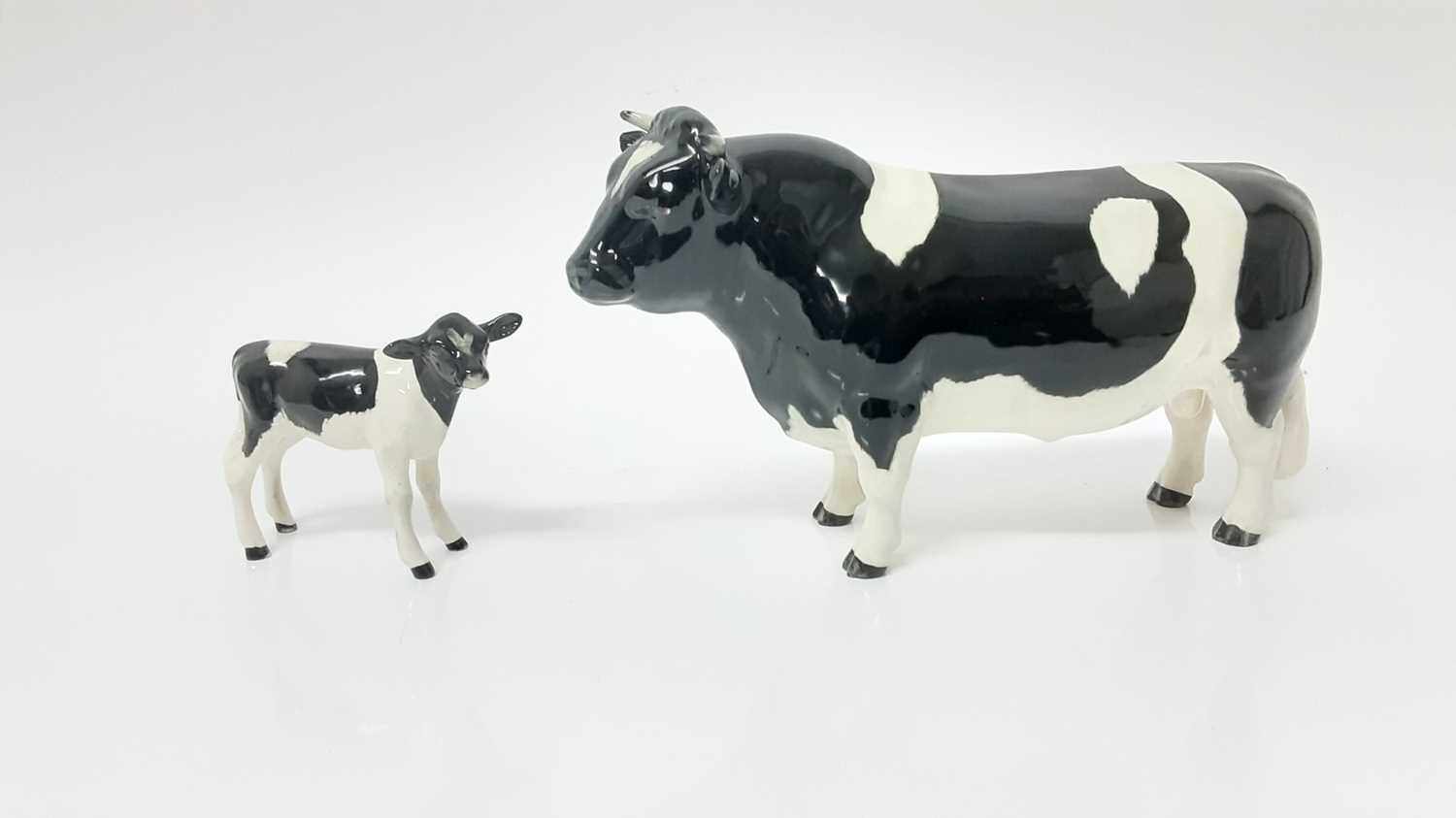 Lot 91 - Beswick Friesian Cow - CH Claybury Legwater, model no. 1362A, designed by Arthur Gredington, 11.9cm high, together with Friesian Calf (2)