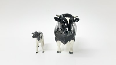 Lot 91 - Beswick Friesian Cow - CH Claybury Legwater, model no. 1362A, designed by Arthur Gredington, 11.9cm high, together with Friesian Calf (2)