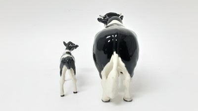 Lot 91 - Beswick Friesian Cow - CH Claybury Legwater, model no. 1362A, designed by Arthur Gredington, 11.9cm high, together with Friesian Calf (2)