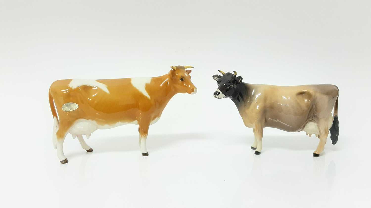 Lot 93 - Beswick Jersey Cow - CH Newton Tinkle, model no. 1345, designed by Arthur Gredington, 10.8cm high, together with Guernsey Cow, and Bull plus a Limousin calf(4)