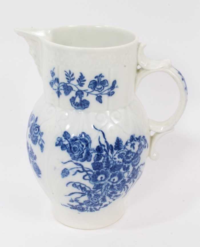 Lot 25 - A Caughley blue and white cabbage leaf moulded jug with mask spout, decorated with bouquets of flowers, S mark to base, 14.5cm high
