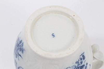 Lot 25 - A Caughley blue and white cabbage leaf moulded jug with mask spout, decorated with bouquets of flowers, S mark to base, 14.5cm high