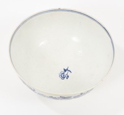 Lot 52 - A rare Isleworth blue and white porcelain bowl, circa 1770, transfer printed with a variation of the Fence pattern on one side, and another Oriental scene verso, with a cornucopia, two birds and a...