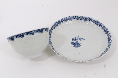 Lot 53 - Worcester blue and white moulded tea wares, circa 1780, including a tea bowl and saucer with floral moulding, and a cup, tea bowl and saucer (5)