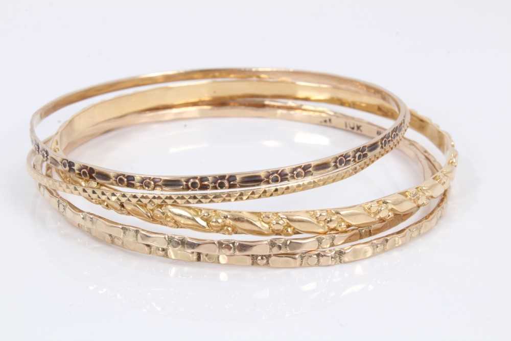Lot 52 - Five gold/yellow metal bangles
