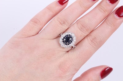 Lot 140 - 18ct white gold sapphire and diamond cluster ring