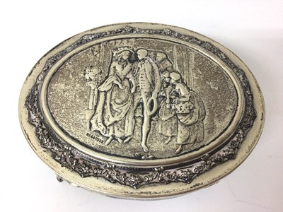 Lot 131 - Edwardian silver oval jewellery box on four legs with relief decoration to lid depicting a couple