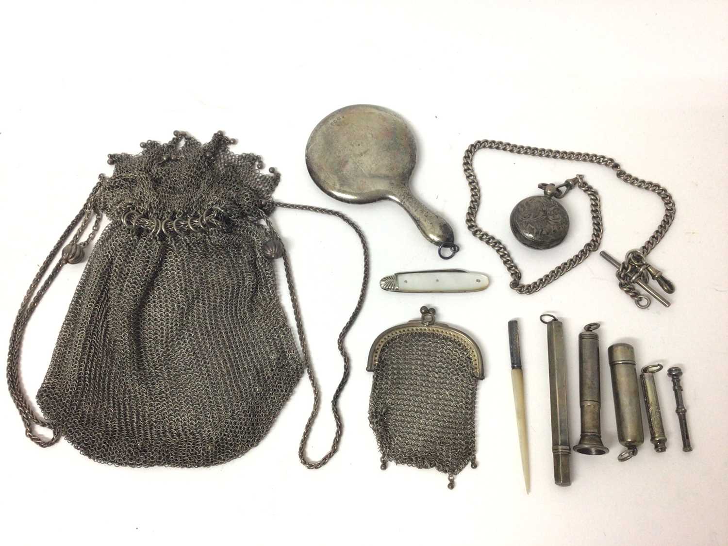 Lot 132 - Two white metal mesh purses, silver sovereign case on silver watch chain, silver propelling pencils, silver cheroot holder, silver and mother of pearl fruit knife, miniature silver mirror and other...