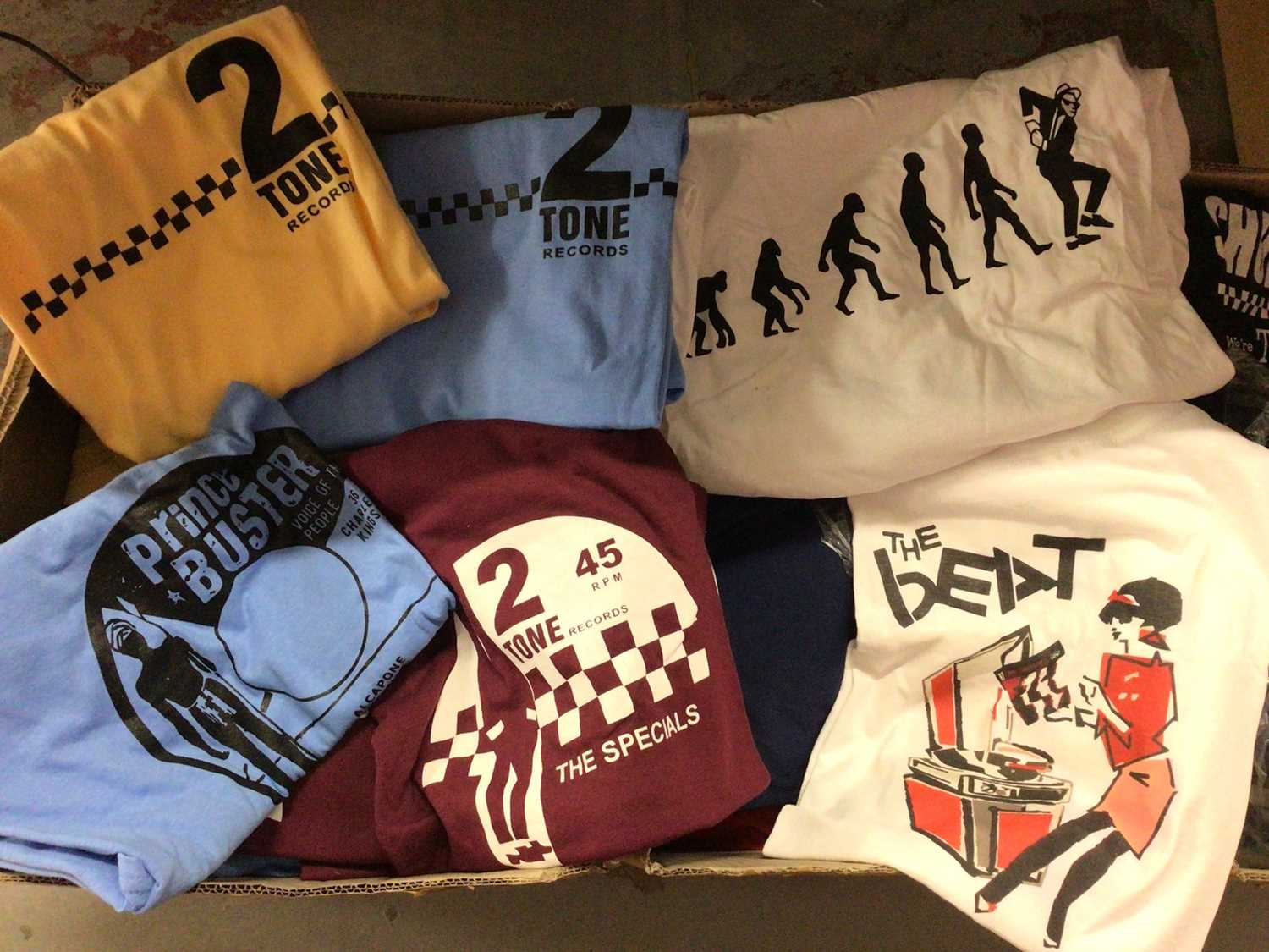 Lot 308 - Four boxes of band, mainly ska, printed T-shirts including Madness, The Beat, 2 Tone Records etc