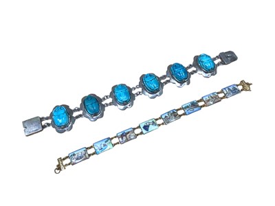 Lot 40 - Egyptian white metal and glazed turquoise scarab beetle bracelet, together with an Egyptian enamelled panel bracelet (2)