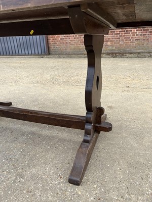 Lot 18 - Early 20th century oak refectory table, with plank top on trestle ends, 163 x 79cm