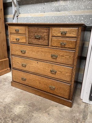 Lot 44 - Edwardian blond oak chest of drawers, with central deep drawer and four short drawers, three long graduated drawers on plinth base, 124w x 53d x 118h