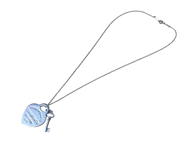 Lot 188 - Tiffany & Co silver 'Return to Tiffany' heart tag with key pendant on chain, with pouch and box