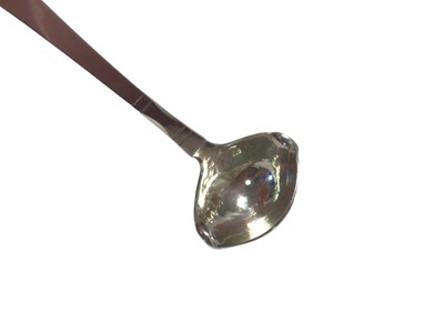 Lot 14 - A Georg Jensen Danish silver double-lipped cream ladle with hammered bowl, Copenhagen mark for 1924, London import marks, 12.5cm long