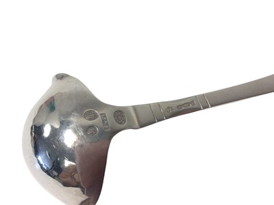 Lot 14 - A Georg Jensen Danish silver double-lipped cream ladle with hammered bowl, Copenhagen mark for 1924, London import marks, 12.5cm long