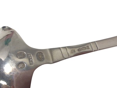 Lot 14 - A Georg Jensen Danish silver double-lipped cream ladle with hammered bowl, Copenhagen mark for 1924, London import marks, 12.5cm long