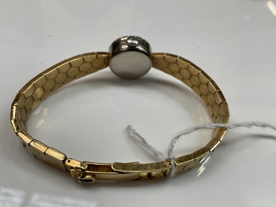 Lot 441 - 1950s ladies 18ct gold Omega wristwatch with diamond bezel