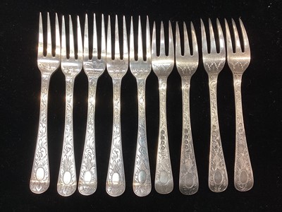 Lot 289 - Set of nine George III silver fruit forks, with engraved foliate decoration