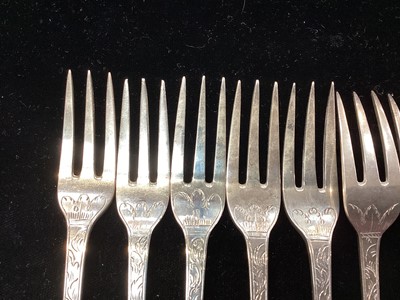 Lot 289 - Set of nine George III silver fruit forks, with engraved foliate decoration