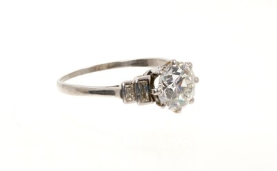 Lot 745 - Art Deco diamond single stone ring with baguette cut diamonds to the stepped shoulders