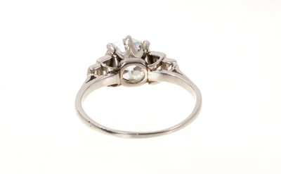 Lot 745 - Art Deco diamond single stone ring with baguette cut diamonds to the stepped shoulders