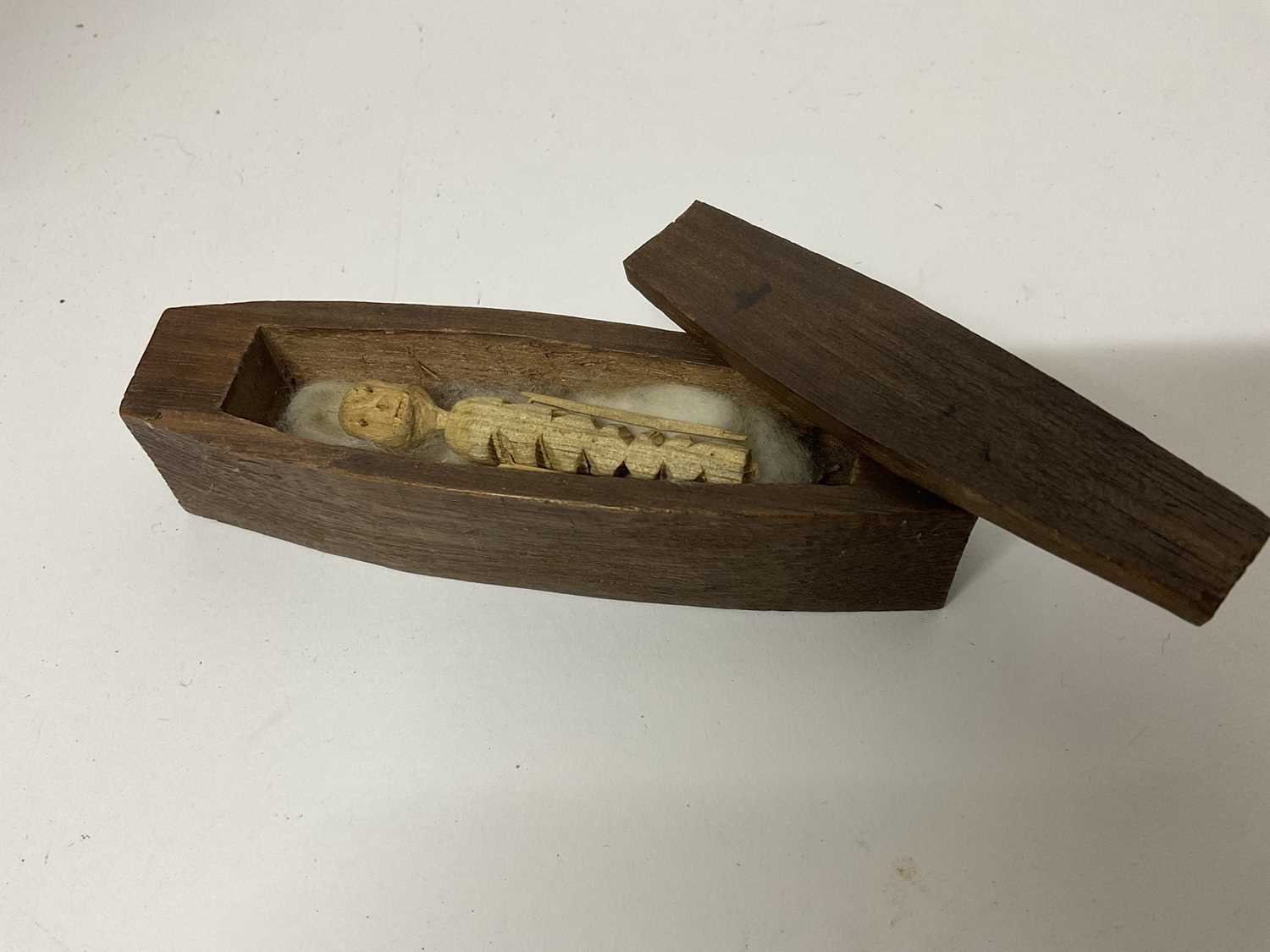 Lot 41 - Rare hand carved softwood poppet, the whittled figure of skeletal appearance, housed with a carved mahogany miniature coffin, 19th century or earlier