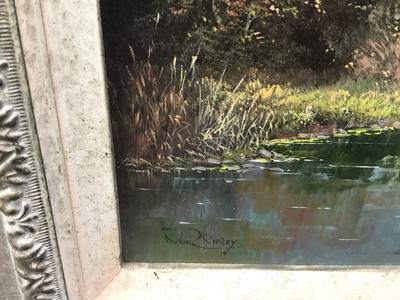 Lot 107 - Noel Ripley (born 1944), oil on board, rural river landscape with a farm in the foreground a church beyond, signed, in gilt frame. 29 x 39cm.