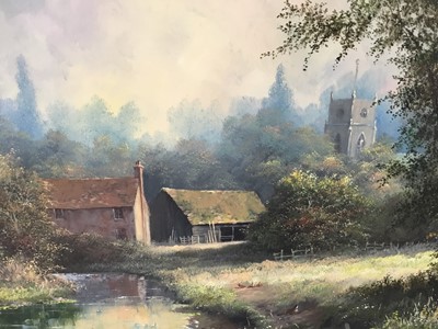 Lot 107 - Noel Ripley (born 1944), oil on board, rural river landscape with a farm in the foreground a church beyond, signed, in gilt frame. 29 x 39cm.