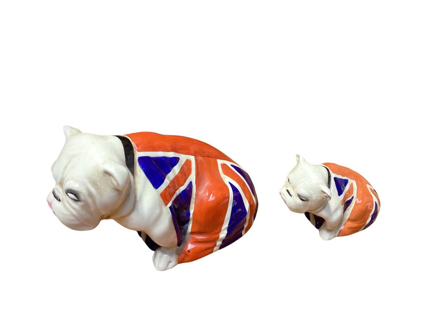 Lot 1106 - Two Royal Doulton bulldogs draped in Union Jack flags