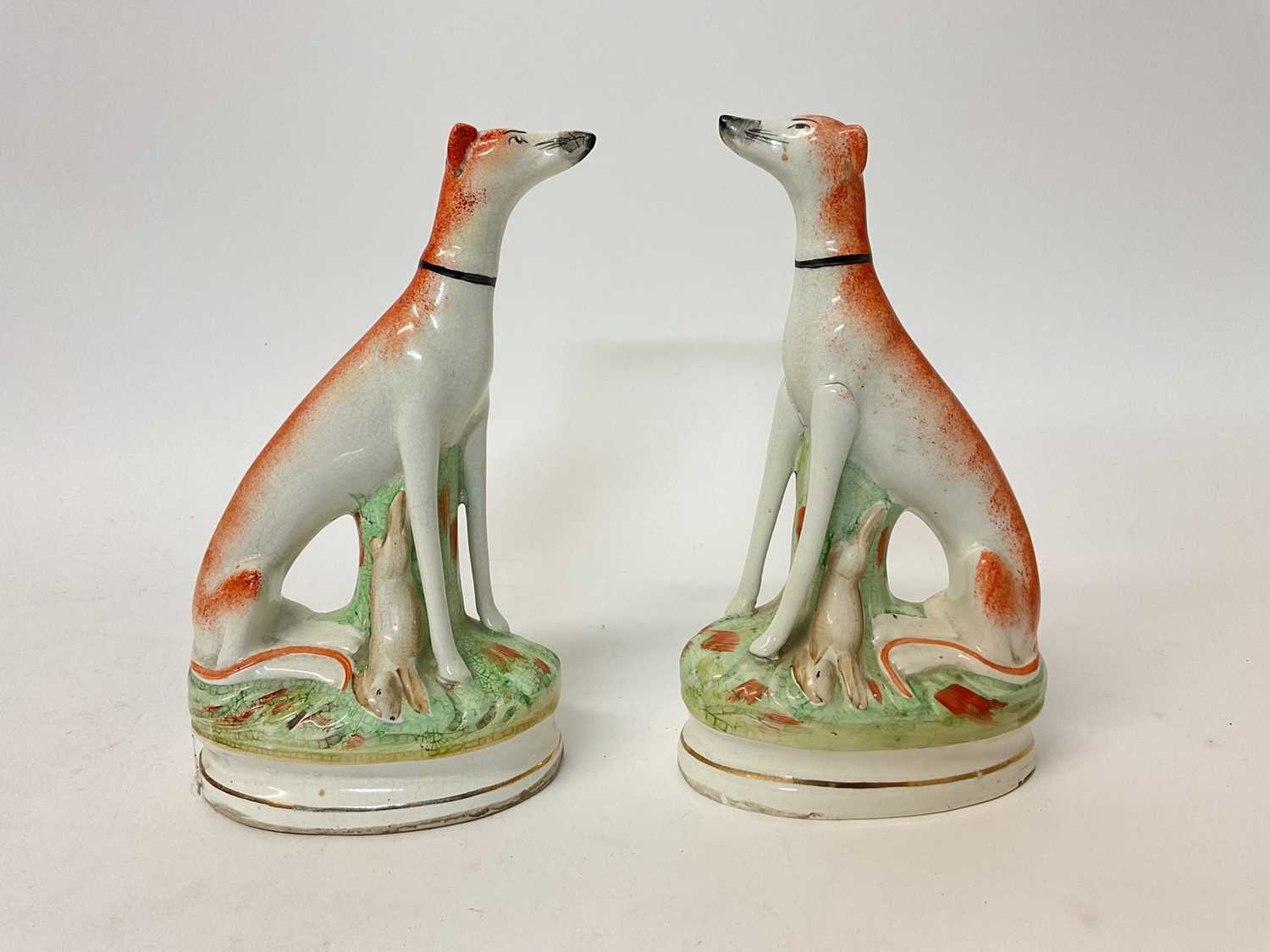 Lot 71 - Pair of Victorian-style Staffordshire pottery models of seated greyhounds, 23cm high