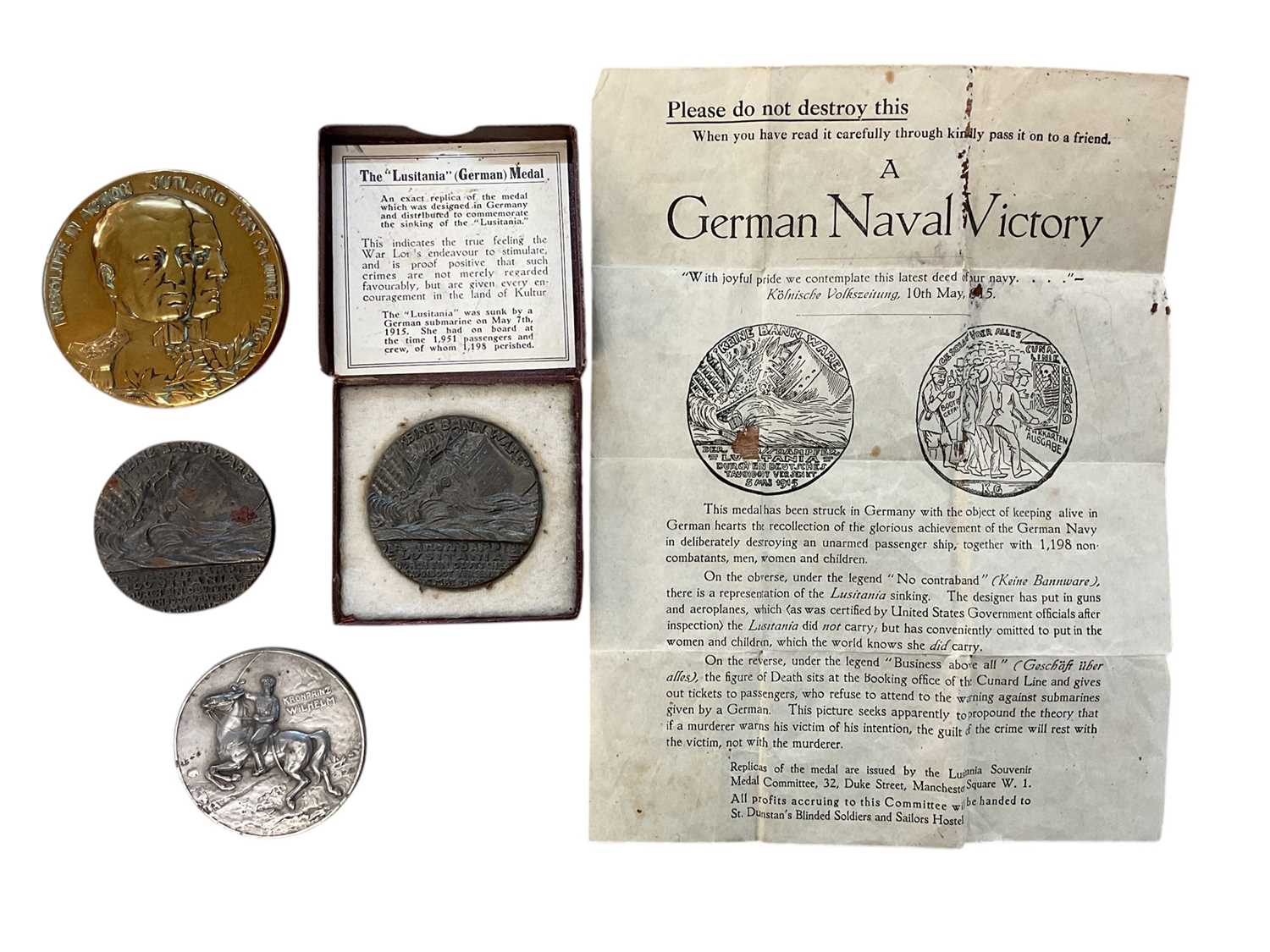 Lot 809 - Group of four medals / medallions to include two R.M.S. Lusitania medals, one boxed, a Jutland medal, and a Verdun medal (4).