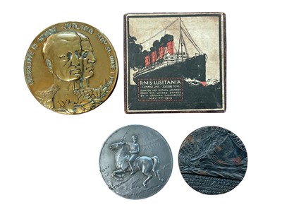 Lot 809 - Group of four medals / medallions to include two R.M.S. Lusitania medals, one boxed, a Jutland medal, and a Verdun medal (4).