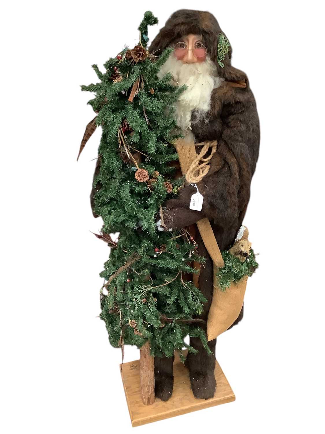 Lot 2790 - Large freestanding Father Christmas holding a Christmas Tree, 138cm in overall height.