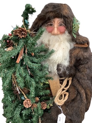 Lot 2790 - Large freestanding Father Christmas holding a Christmas Tree, 138cm in overall height.