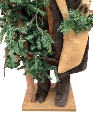 Lot 2790 - Large freestanding Father Christmas holding a Christmas Tree, 138cm in overall height.