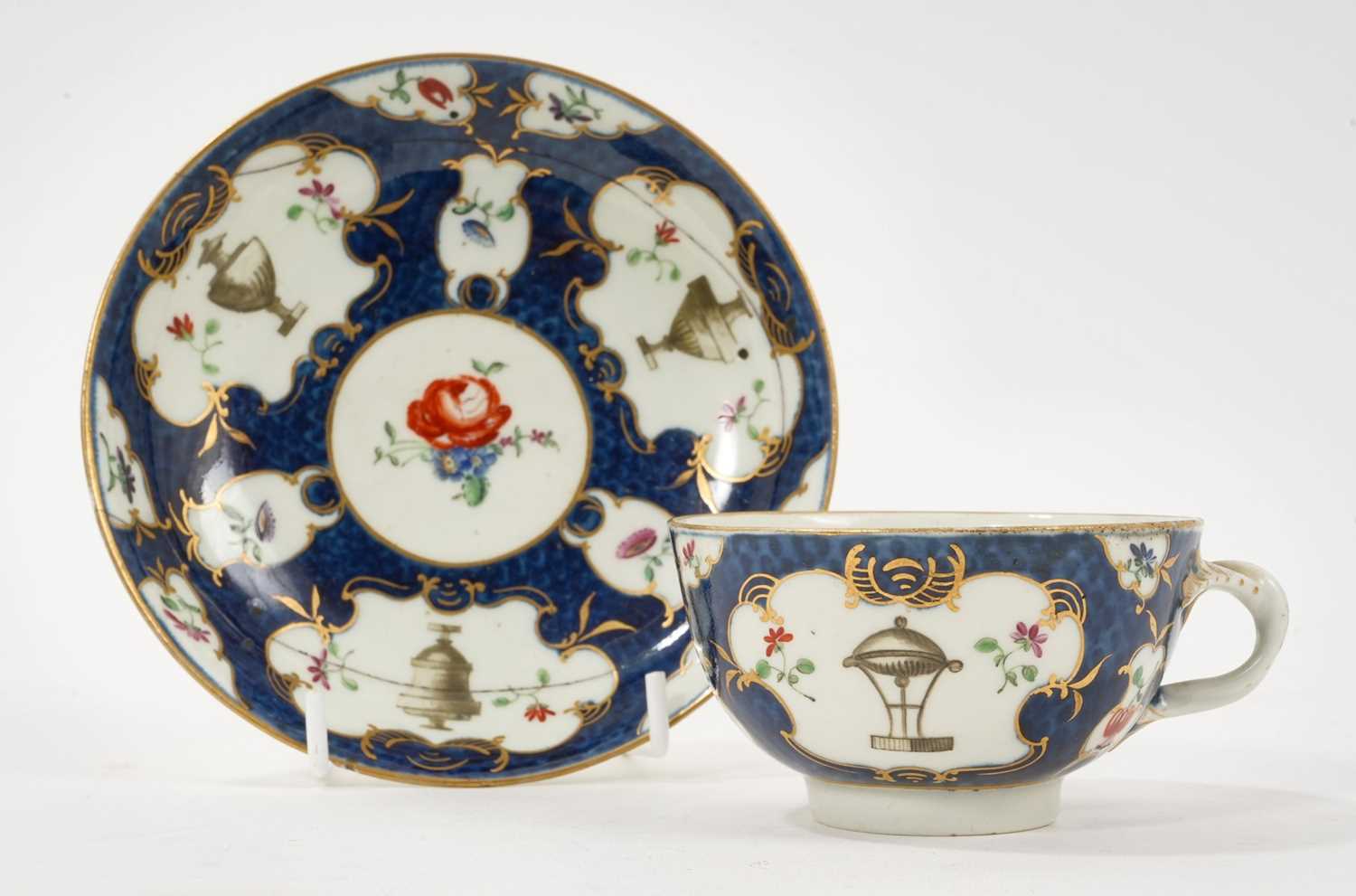 Lot 5079 - Worcester blue scale ground teacup and saucer, painted in the workshop of James Giles with urns and flowers, circa 1765-70