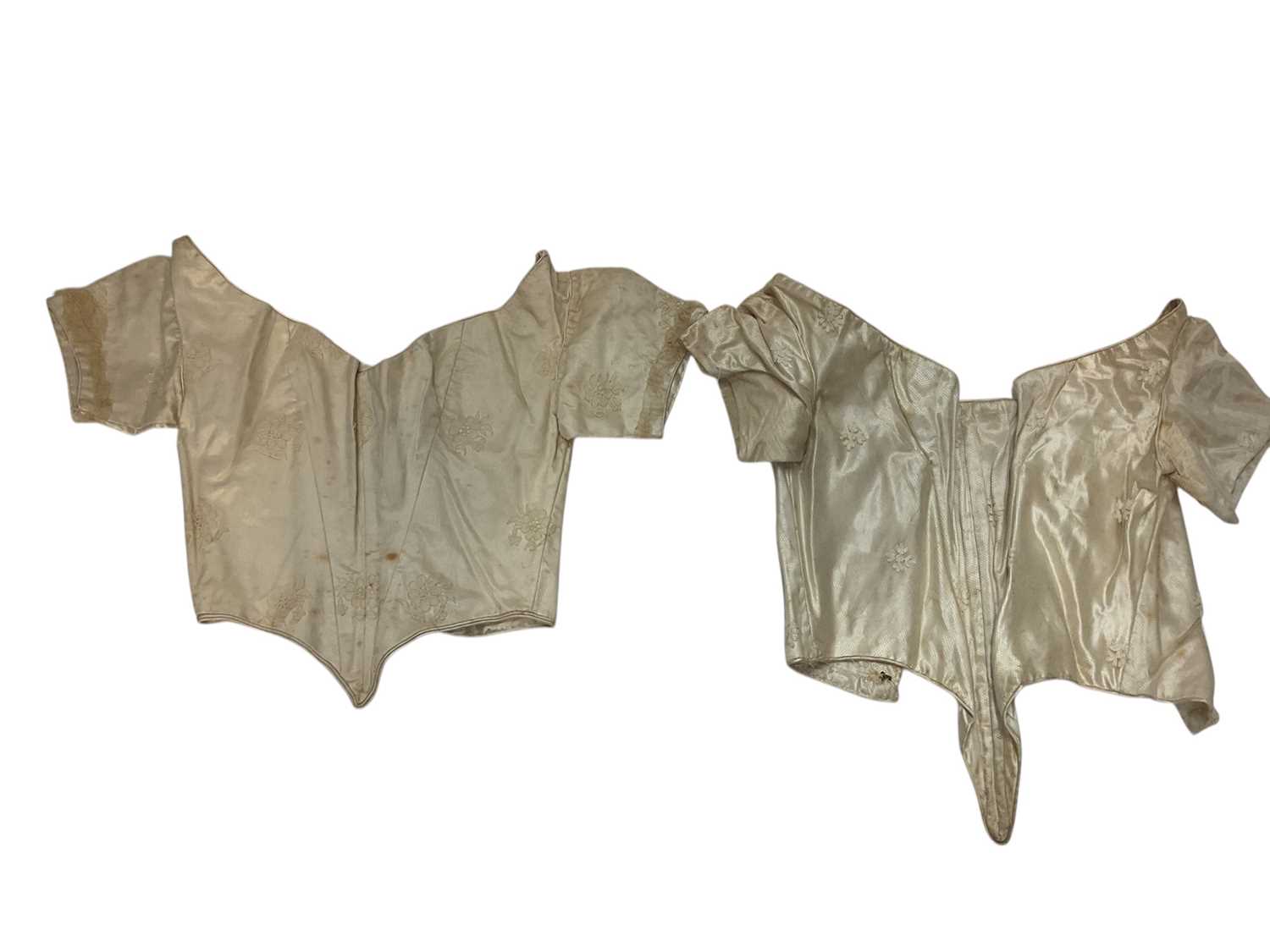 Lot 2056 - Box containing two Victorian embroidered net lace wedding bodices pointed at waistline, Mechlin lace fichu, one other lace fichu and a Honiton lace collar.