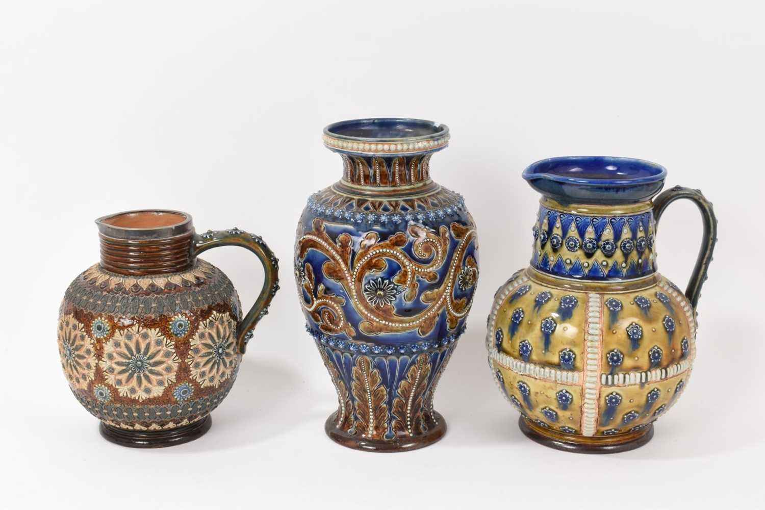 Lot 88 - Victorian Doulton baluster vase, probably by George Tinworth, and two similar Doulton jugs