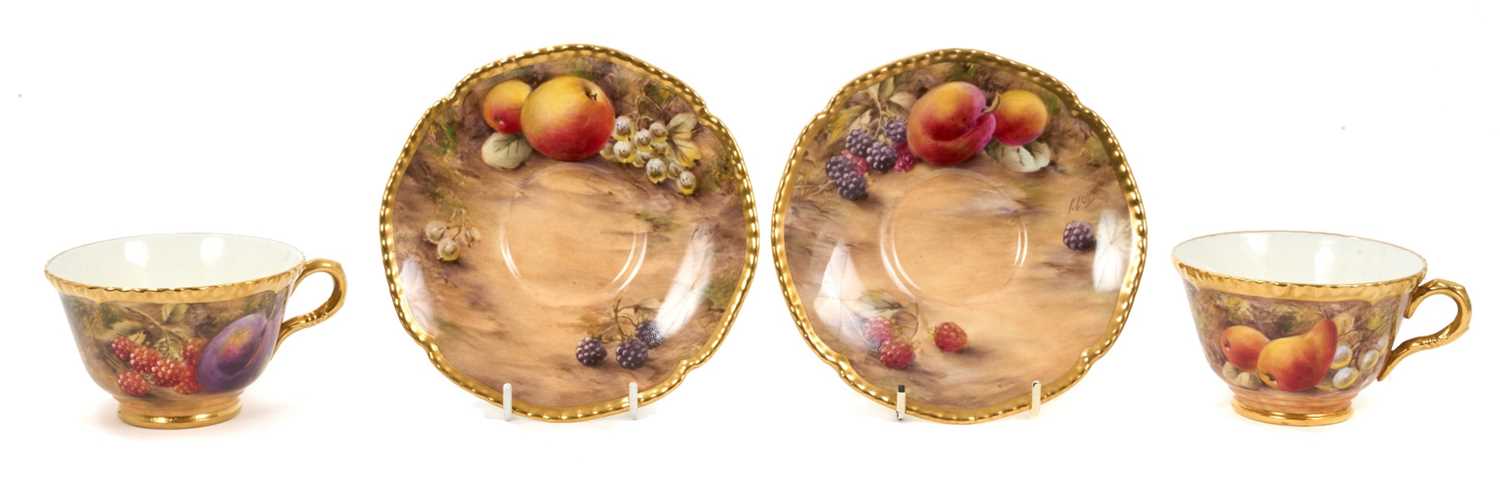 Lot 101 - Pair of Royal Worcester cabinet cups and saucers, dated 1954/55, painted with fruit, signed P. Love, the saucers 15cm diameter