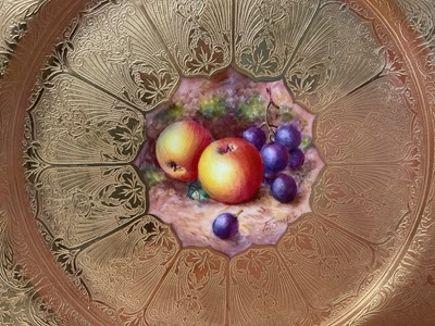 Lot 48 - Two Royal Worcester plates, the first with central panel painted with fruit, signed by Freeman, on gilt-tooled ground, the other with central gilt-tooled rose, marks to bases, each 27cm diameter...