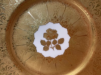 Lot 48 - Two Royal Worcester plates, the first with central panel painted with fruit, signed by Freeman, on gilt-tooled ground, the other with central gilt-tooled rose, marks to bases, each 27cm diameter...