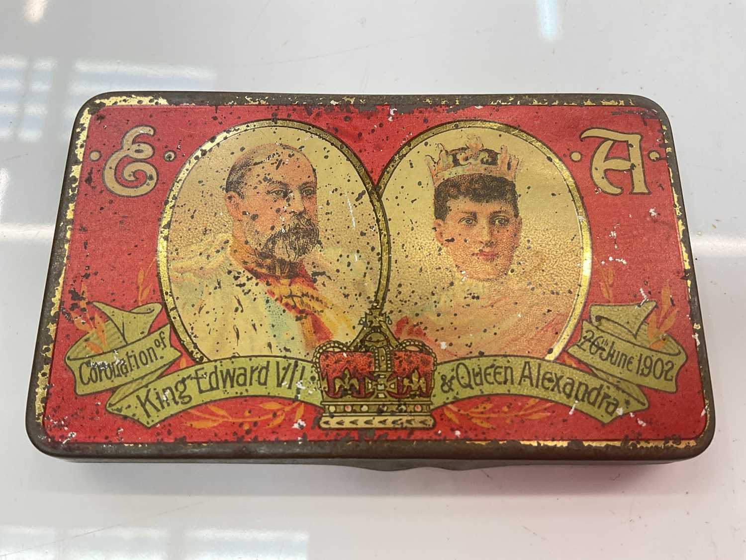 Lot 378 - A commemorative chocolate tin for the Coronation of King Edward VII & Queen Alexandra, 26th June 1902, still contains the original uneaten Cadbury's chocolate.