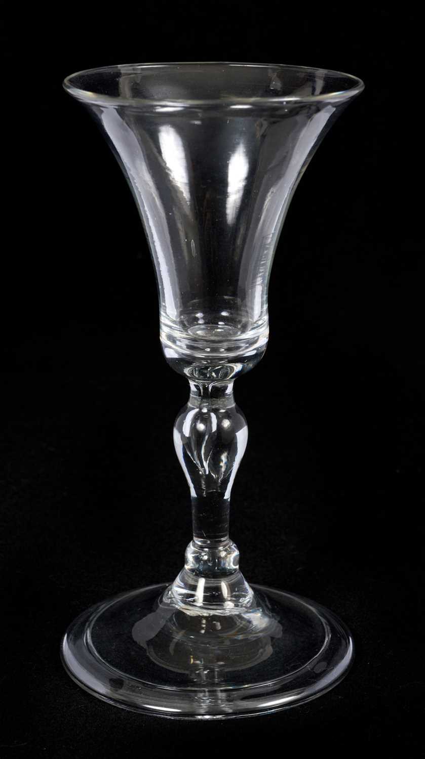 Lot 62 - Baluster wine glass, circa 1730-40, with a bell shaped bowl, on a stem with teared inverted baluster and basal knops, folded foot, 14.75cm high