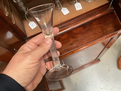 Lot 63 - Three mid 18th century air twist wine glasses, including one corkscrew twist, and two multi spiral, 13.75cm to 17.75cm high (3)