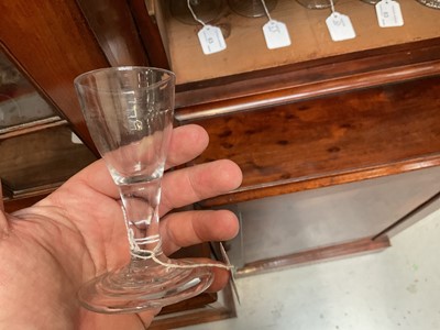 Lot 66 - 18th century firing glass, with fluted round funnel bowl, double series opaque twist stem, and stepped foot, together with another firing glass with fluted bowl and stepped foot, 10cm and 10....