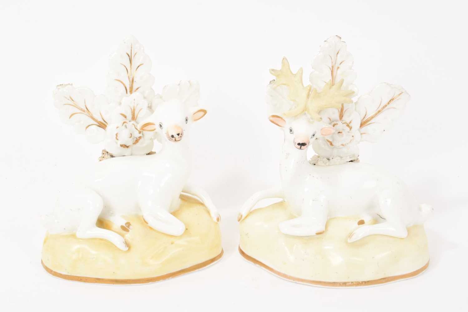Lot 102 - Pair of Samuel Alcock porcelain figures of a doe and stag, circa 1830, sparsely decorated, shown seated on gilt-lined bases, 11.5cm high