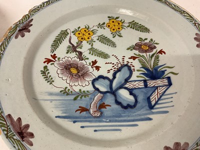 Lot 130 - Two 18th century Delft dishes, polychrome painted in the Chinese style with fence patterns, one with a bird, 35cm and 34.5cm diameter