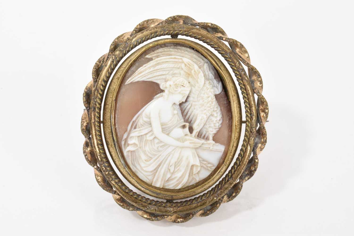 Lot 522 - 19th century Italian carved shell cameo depicting Hebe, Greek goddess of youth feeding an eagle, in a gilt metal revolving brooch mount with glazed portrait to the reverse
