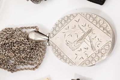 Lot 530 - Victorian white metal oval locket pendant with engraved bird decoration on chain, together with other silver and white metal jewellery