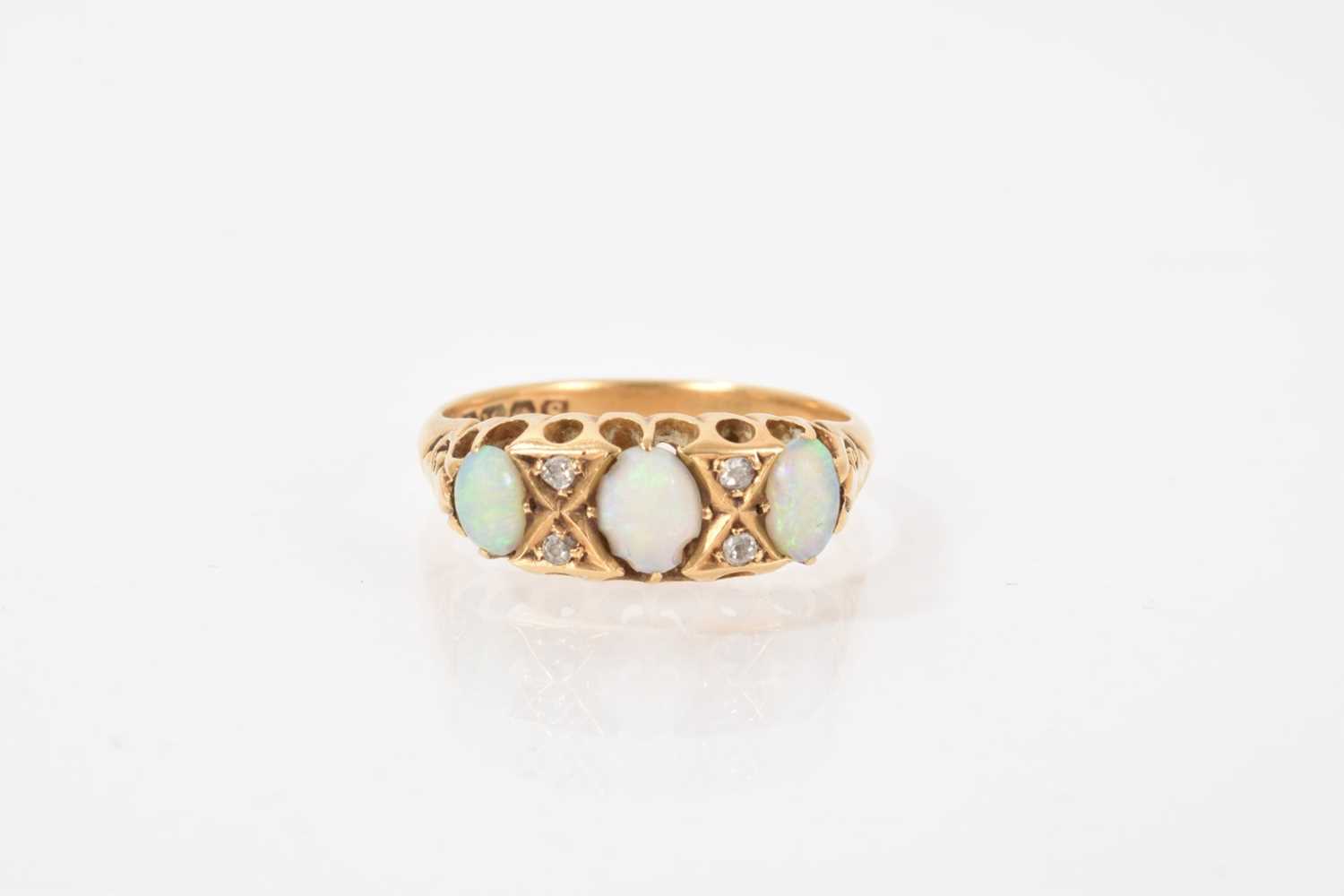 Lot 531 - Opal and diamond ring with three opal cabochons interspaced by four old cut diamonds in carved gold claw setting on 18ct gold shank, (Birmingham 1918)